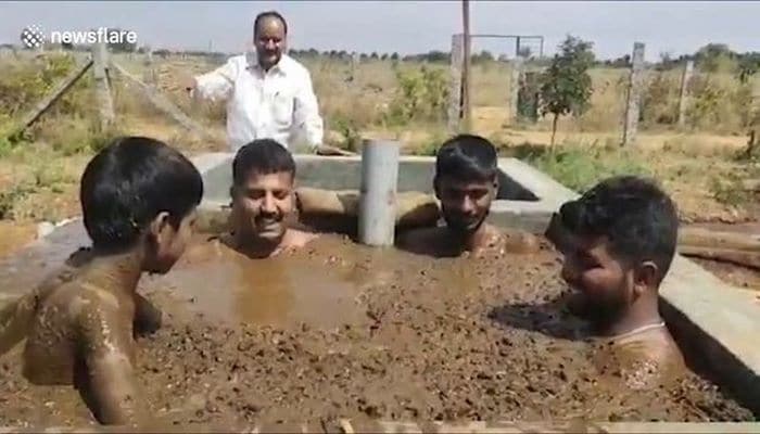 В Индии люди принимают навозные ванны в целях защиты от вирусов